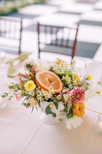 Bright floral centerpieces mixed with colorful fruit at Glen Foerd Estate in Philadelphia, PA