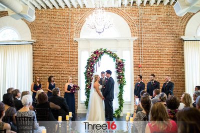 Bride and Groom face each other at the altar at  the Estate on Second wedding venue in Santa Ana