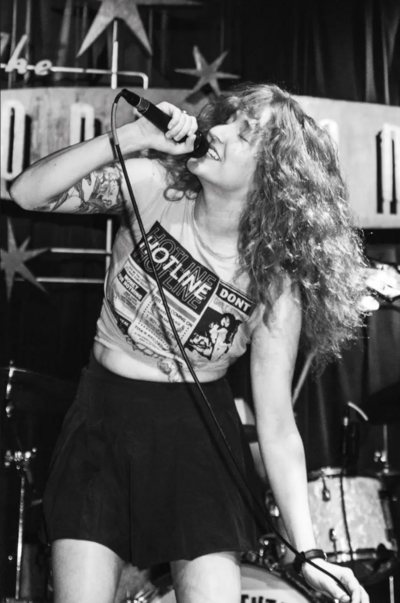 Allison singing into the mic at The Continental Club in Houston, Texas.