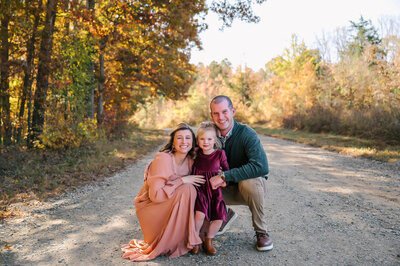 a family of five sitting on a park at coker arboretum and having their photo taken by rosa ashdown