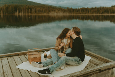 photo of a girl and boy on a picnic on a pier