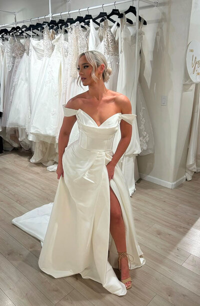 Private Label collection photo of model bride wearing modern, clean a line wedding dress with slit.