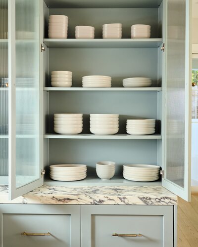 Dishes organized in glass cabinet