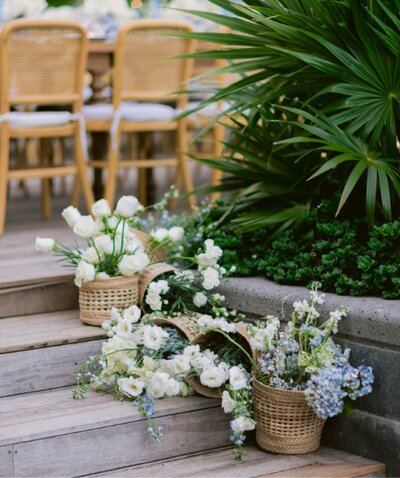 Flowers artfully arranged on wooden steps at a tropical destination wedding