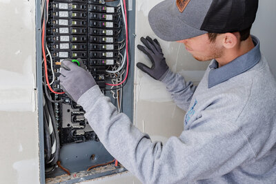 Dove Electric Electrician installing circuit breaker in Albuquerque NM
