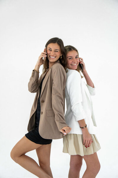 Two women smiling and talking on the phone