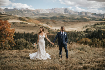 Couple holding hands on their Telluride elopement day.