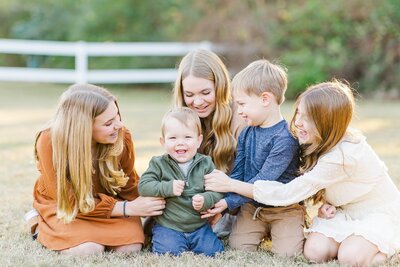 children laughing together at family photo session in Auburn AL