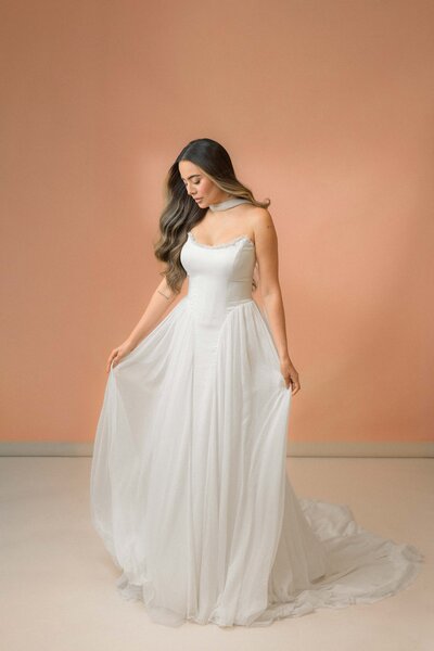 Styled high-low wedding gown paired with statement bridal heels and accessories