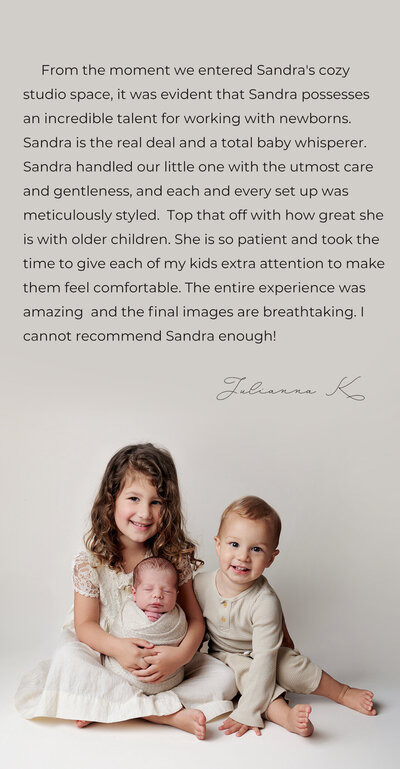 5 year old girl and her 2 year old boy posed close together holding their newborn brother. The babu is upright on her lap and swaddled in a soft knitted wrap