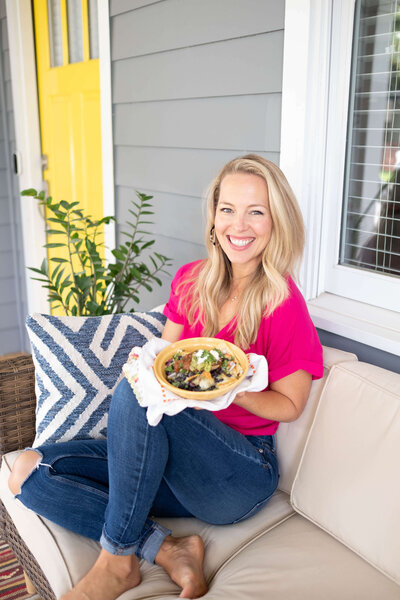 A happy, healthy mom enjoying nachos on her porch