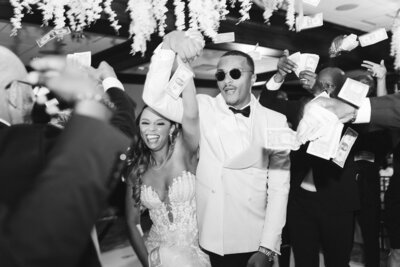 Bride and Groom walking through a tunnel of bridal  parties arms raised