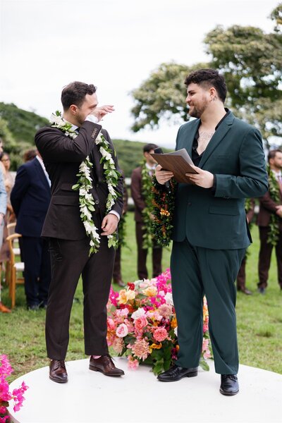 A person wiping tears as they talk to their officiant during their wedding ceremony 