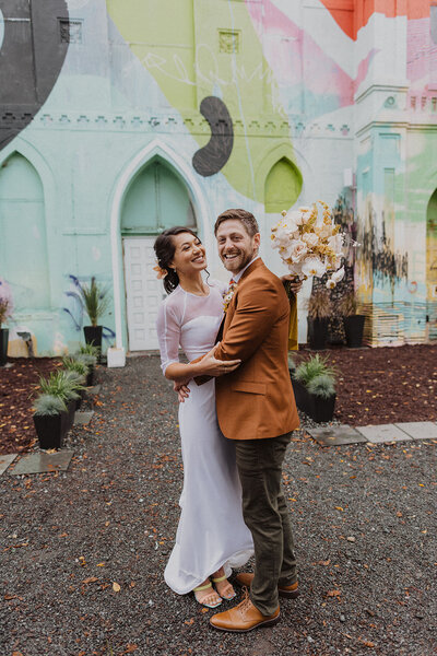 Couple poses in front of Culture House wedding Venue in DC