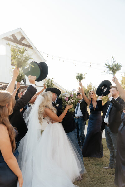 bride and groom surrounded by friends on wedding day