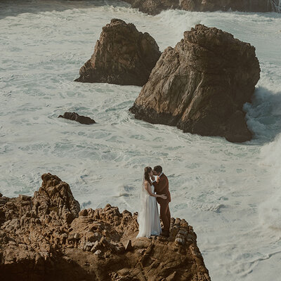 Big Sur Elopement Photographer- couple enjoying some time together laying down on a picnic blanket