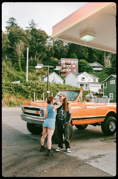 couple standing in front of vintage car caught on film