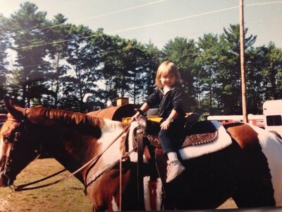 Hiliary at age 3 riding a red and white paint at her first horse show