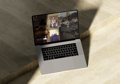 Clean image of a laptop open on stone featuring Freestone Creative page with of branding and style boards and text that says adventure life