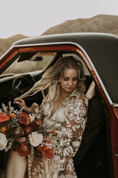 bride posing in the seat of a car