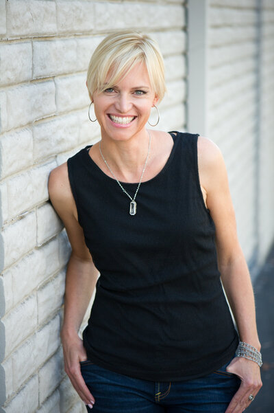 Personal branding headshot of Lani Merlina of Merlina Design wearing black tank top and smiling at camera.