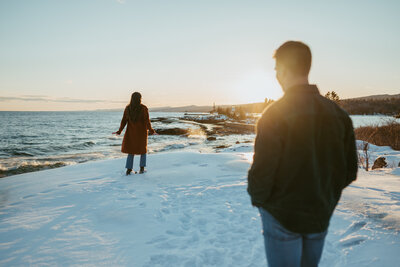 man look at woman dancing at the sunset