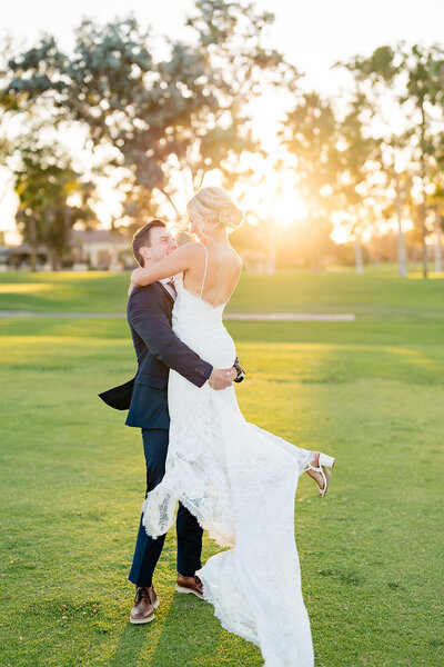 Bride and Groom kissing in vineyard at Falkner Winery