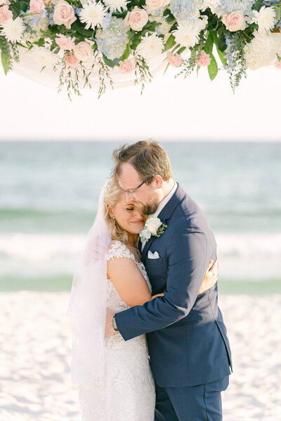 Bride and Groom embrace after their wedding ceremony on the beach in Destin, Florida