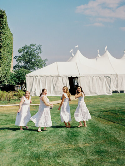 A group photo of the bridesmaids about to enter the wedding tent. 