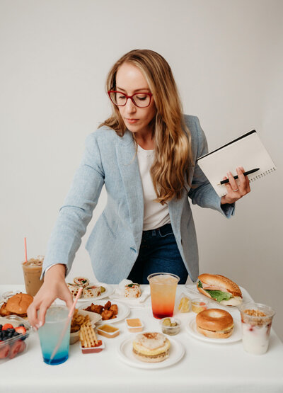 Rachel Toner grabbing a drink off a table of food