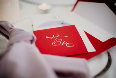 Classy and minimalist red wedding invitation pocket with couples monogram