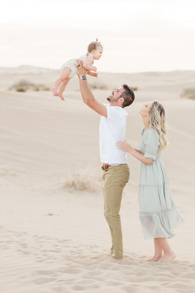 Sweet, romantic photo of a couple. He is carrying her in his arms while walking across Sleepy Ridge  Golf Course towards the Venue. Photo taken by Utah Wedding Photographers Andria Joleen Photography