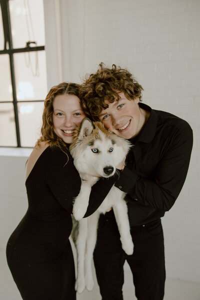 photo of missouri wedding photographer holding a dog
