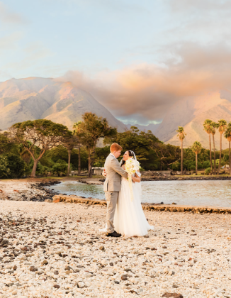 west maui mountains at sunset with bride and groom in the foreground