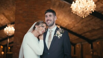 Newly married couple gazing out of the window at Hidden River Barns Carlisle shot by Anthony Horseman wedding videographer and photographer
