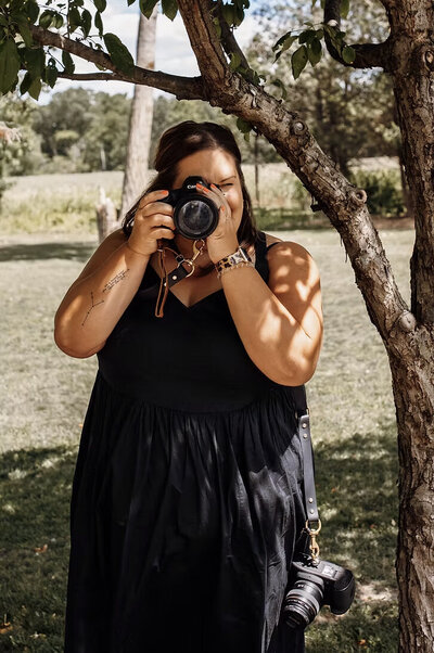 Headshot of Kati holding camera up to face