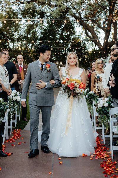 Arizona Luxury Wedding Photographer and Videographer Bride and Groom Walking Down Aisle Together