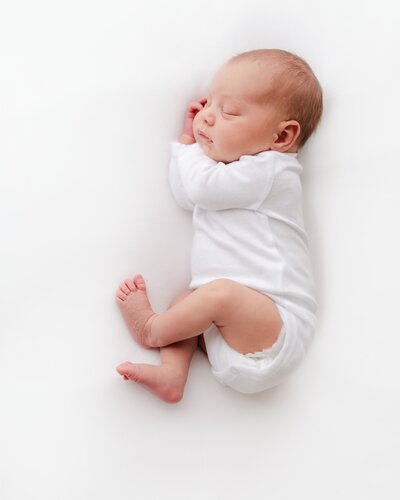 Sleeping newborn during her session in Pensacola FL studio