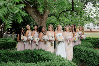 bride posing with bridesmaids atlanta wedding venue