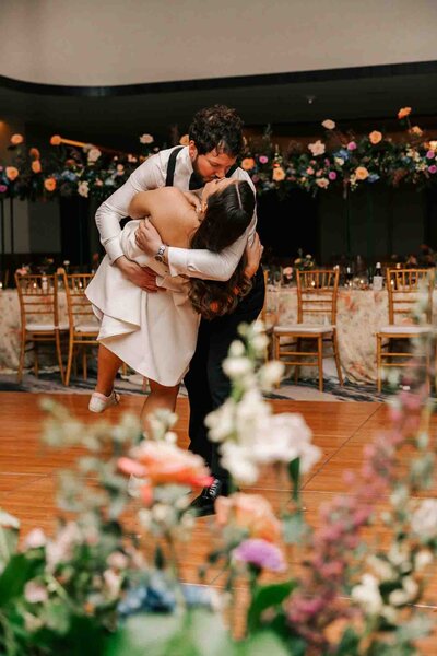 groom dips his new wife on the dance floor of their recpetion at the four seasons hotel
