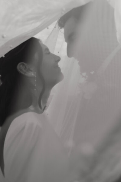 Bride and Groom walk alongside shoreline