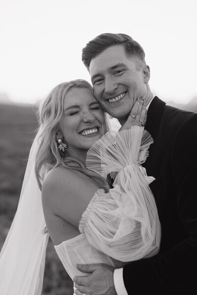 All smiles during bride and groom photos during their mountain wedding
