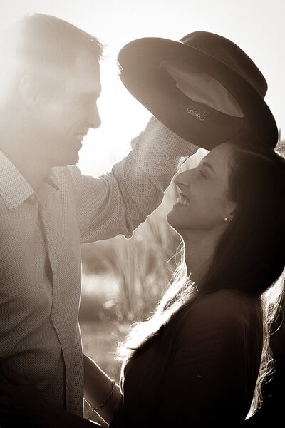 Man putting his hat on the woman