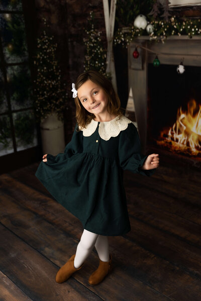 Little girl standing in a Christmas themed set in an Erie PA photography studio
