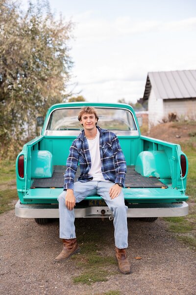 senior guy sitting in vintage truck