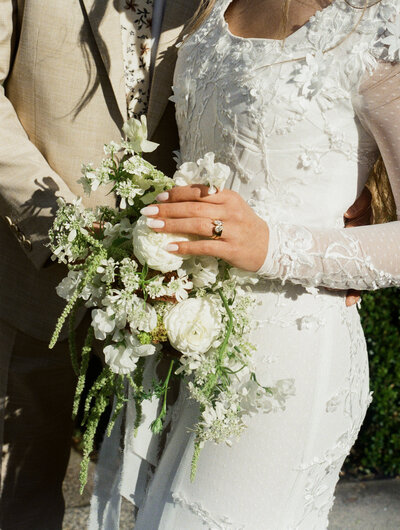 groom holding bride and smiling at each other