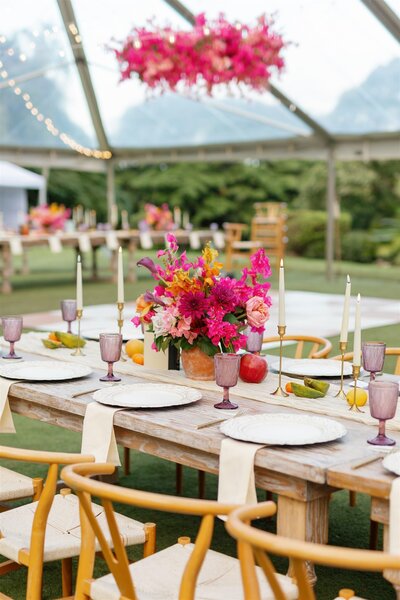 Floral arrangements and plate ware on wedding reception table 