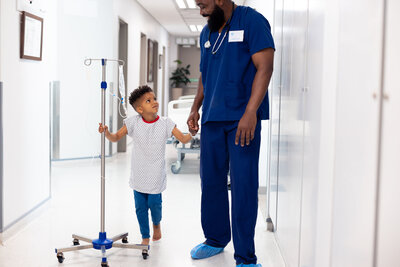happy-african-american-male-doctor-holding-hand-of-2023-11-27-04-57-56-utc