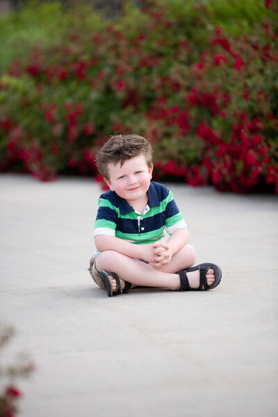little boy sitting near the Idaho State Capitol Building in Boise.