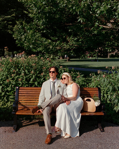 joyful pair on bench soaking in their civil ceremony